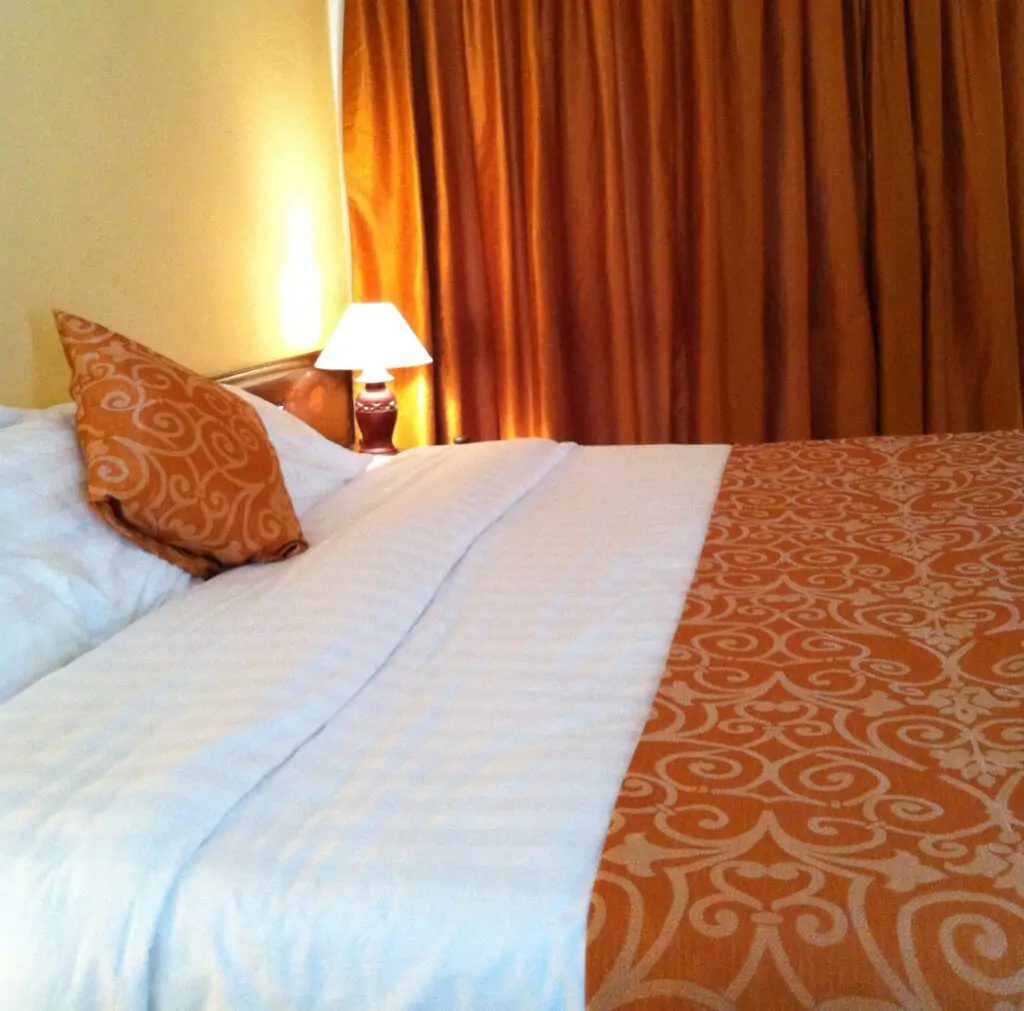 Bed detail in a deluxe room with coastal fabrics — Kenya Bay Beach Hotel, Bamburi Beach Mombasa