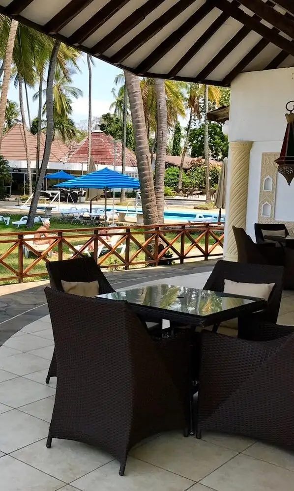 Restaurant terrace overlooking the pool and gardens